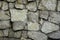 Stone wall natural gray green boulders with cement ties