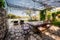 Stone wall, outdoor stone table and chairs, garden yard relaxing space