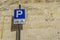 Stone wall with parking sign for bike and bicycle blue parking s