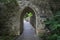 Stone wall with a pointed arch passage.