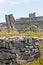 Stone wall with the ruins of O`Brien`s castle in the background, n Inisheer, Aran islands, Ireland