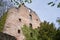 Stone wall of the ruins of an old castle of Schloss Neuenburg in Germany, overgrown with ivy, in spring.