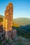 Stone wall ruins overlooking valley sunset