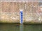 Stone wall of sluice with gauge