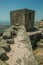 Stone wall and square tower on hilltop at the Castle of Monsanto