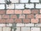 Stone wall, which is inaccurately finished with white and red ceramic tiles.