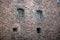 Stone wall with windows loopholes of an old Swedish castle in Vyborg