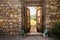 Stone wall, wooden doors opening, iron lion statues,outdoor entrance mediterranean villa