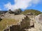 Stone walled path leading through the unique Incan designed trapezoidal doorway at Machu Picchu, Peruvian Andes, South America