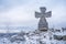 Stone war cross near Lookout tower Stepanka on the border of Krkonose and Jizera Mountains. Winter overcast day, sky