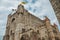 Stone watch-tower, walls and flags inside the Gravensteen Castle at Ghent.