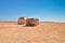 Stone wells with water in the desert, against the background of a low elevation