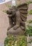 Stone winged, seated gargoyle statue at an entrance to Dragon Park in the Oak Lawn neighborhood of Dallas, Texas.