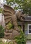 Stone winged, seated gargoyle statue at an entrance to Dragon Park in the Oak Lawn neighborhood of Dallas, Texas.