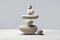 A stone zen composition captures the essence of minimalistic simplicity and tranquility. Balanced rock stacks on a gray and white
