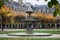 stoned fountain in vosges square in Paris by autumn