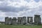 Stonehenge - cloudy skies and green meadows.