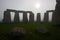 Stonehenge at dawn on a foggy day