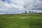 Stonehenge - green meadows and cloudy skies.