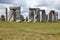 Stonehenge historic site on green grass under blue sky. Stonehenge is a UNESCO world heritage site in England with origins