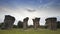 A Stonehenge of Thailand under clear blue sky in front of green grass location