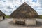 Stonehenge traditional mud hut replica, in England