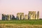 Stonehenge, warm pink sky, green summer meadow. Prehistoric monument in Wiltshire, United Kingdom. Historic Neolithic Stones.