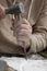 stonemason with ancient costume during the processing of the stone with chisel