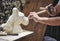 A stonemason carving a statue of a horse`s head