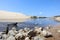 Stones alongside the flowing water. Estuary stream dunes on a beach on beautiful day in Huchet France.Calming atmosphere concept