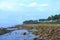 Stones at Beach with Littoral Forest and Blue Sky in Background - Landscape at Neil island, Andaman Nicobar Islands, India