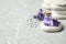 Stones, bottle of essential oil and lavender flowers on marble table. Space for text