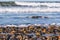 Stones Covering South Carlsbad State Beach with Crashing Waves