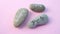 Stones with german words for Love, Believe and Hope on rotating pink background