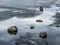 Stones lying on the melting ice of a frozen river