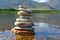 Stones meditation figures. Symbolical statue of several stones. Tradition to collect  stones in private. Beautiful water landscape