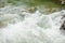 Stones and mountain river with small waterfall, blurred background, the flow of a mountain river