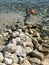 Stones pebbles rocks in sea orange buoy