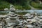 Stones pyramid. Balancing Zen stones on the river bank. Stone Stacked on green nature background. Rock cairn