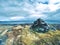 Stones pyramid on gravel mountain summit. Daybreak horizon