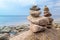 Stones pyramid on the seashore. Sunset on pebble beach. Balanced life, relax