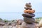 Stones pyramid on the seashore. Sunset on pebble beach. Balanced life, relax