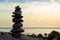 Stones pyramid on the seashore. Sunset on pebble beach. Balanced life, relax.