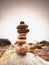 Stones pyramid symbolizing zen, harmony, balance pebbles. Ocean in background