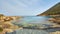 Stones and rocks in forefront with creamy surf ebbing and flowing on Polis beach, Cyprus