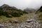 Stones and rocks on mountainside in fog