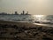 Stones on the sandy beach. Quiet place. The silence of the waves Edge of the coast. Background of sand and stone. Black sand on