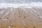 Stones at a sandy pebble beach with the sea withdrawing