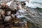 Stones on the sea beach. Pasture winter day. Clear water and sand. Kyrgyzstan, Issyk-Kul Lake