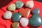 Stones in the shape of heart lie on a red background. Heart made of natural quartz stone, rhodochrosite, jade, aventurine and